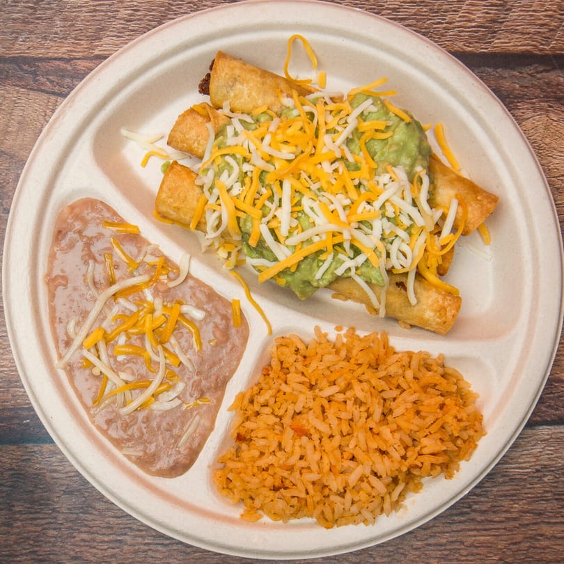 Eduardos Taco Shop taquitos with guacamole, cheese, refried beans, and Mexican rice on a plate.