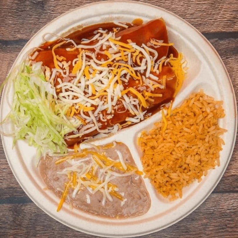 Eduardos Taco Shop's enchiladas with red sauce, shredded cheese, lettuce, rice, and refried beans.