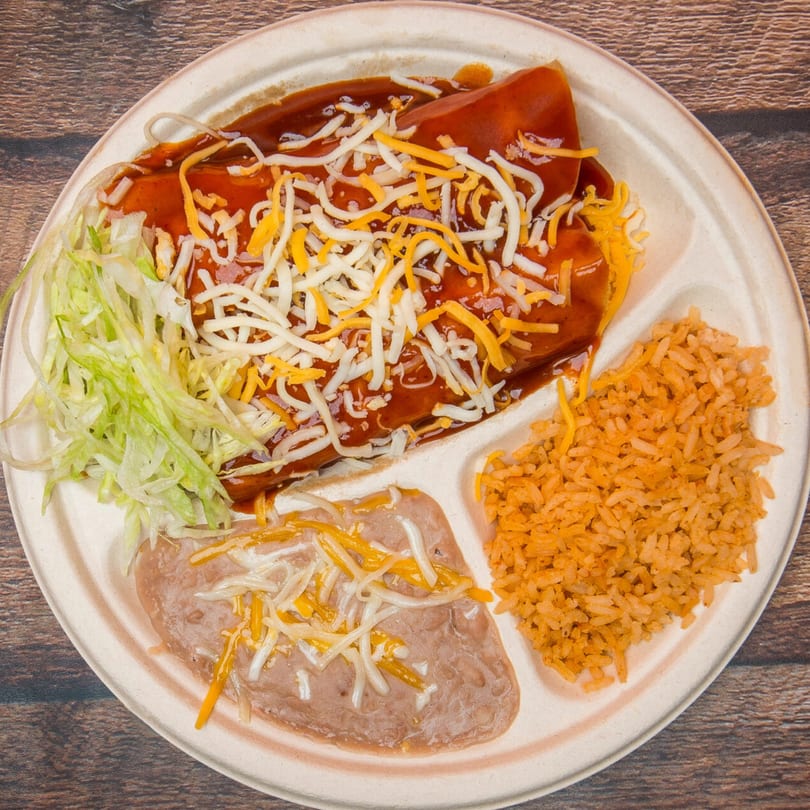 Eduardos Taco Shop's enchiladas with red sauce, shredded cheese, lettuce, refried beans, and rice.